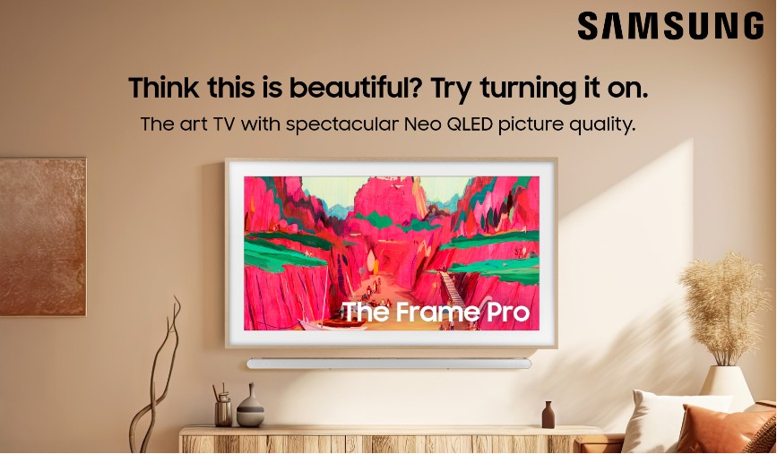 Samsung The Frame Pro LS03FW Art Mode 4K TV displaying vibrant artwork in a living room setting.